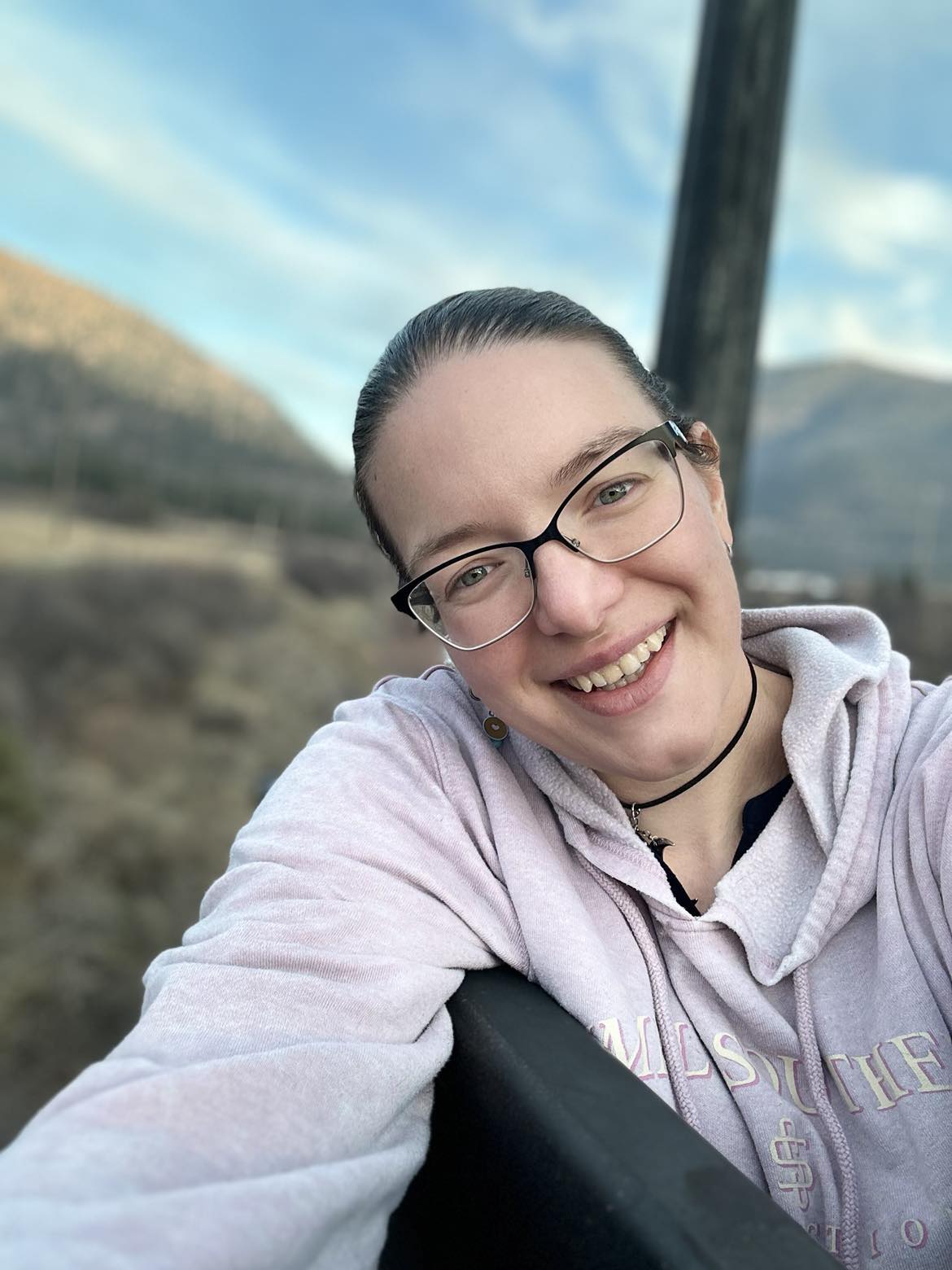 Audria smiling on a bridge